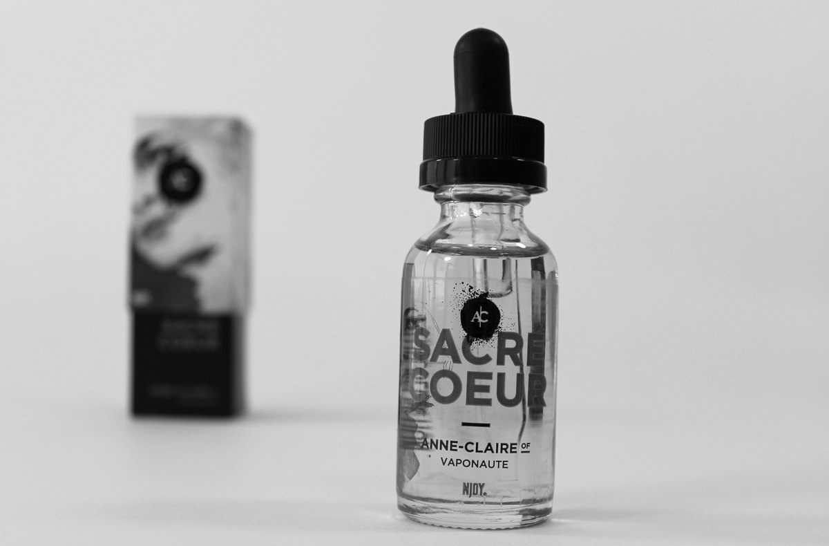 E-liquid bottle next to a compact vape device