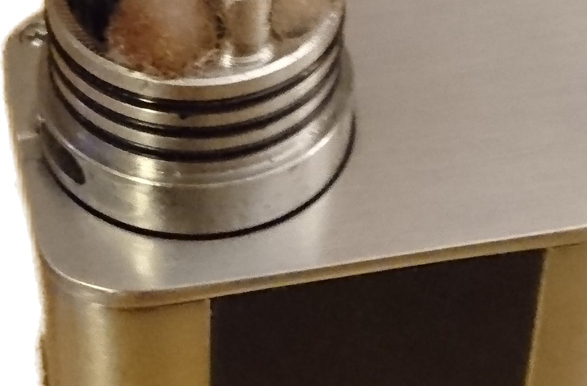 Close-up of a rebuildable atomizer deck with an exposed coil