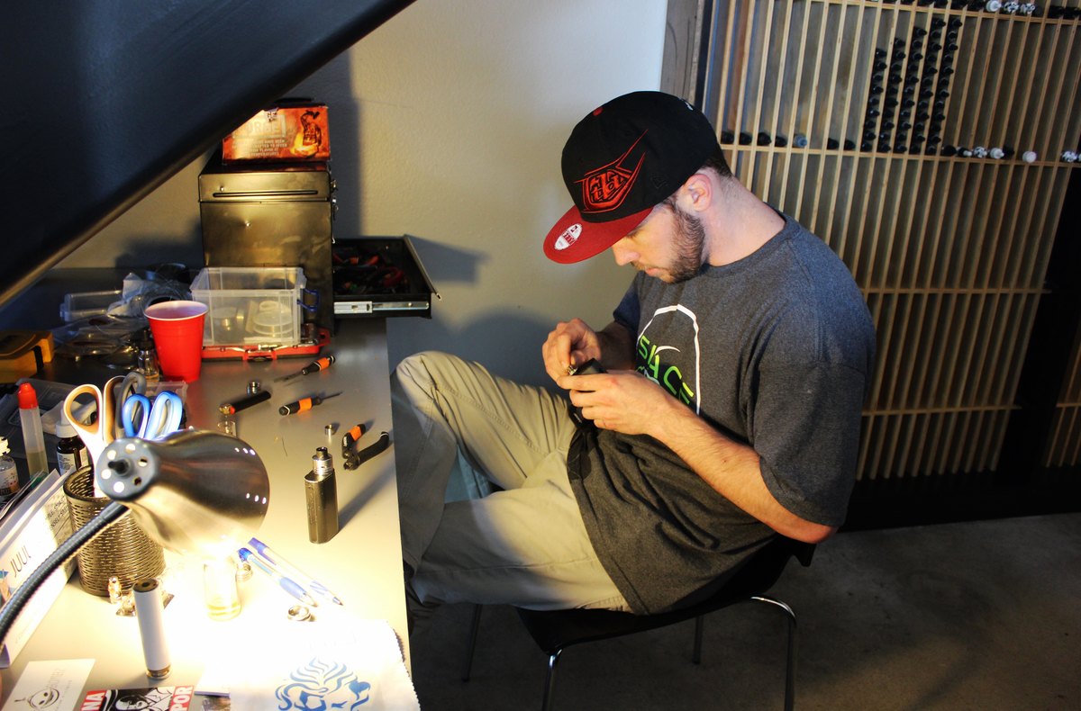 Close-up of an electronic cigarette atomizer coil being rebuilt
